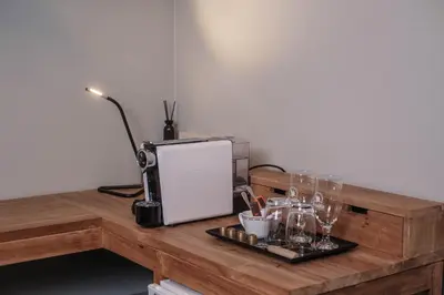a wooden table with glasses and a microwave on it at Craywinckelhof Wagenhuis Horst in Lubbeek