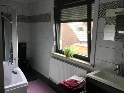 a bathroom with a window and a tub and a sink at Gesloten in Geraardsbergen