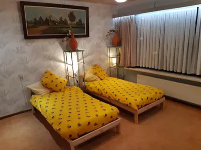 two beds with yellow pillows in a room at CASA DI MARCO in Antwerp
