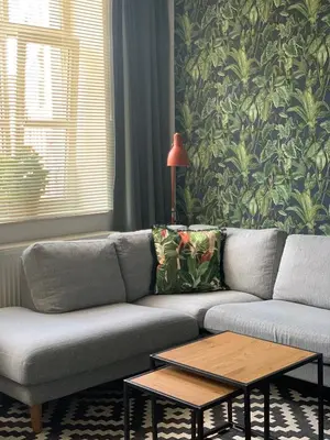 a living room with a couch and a table at Anna Place in Ghent