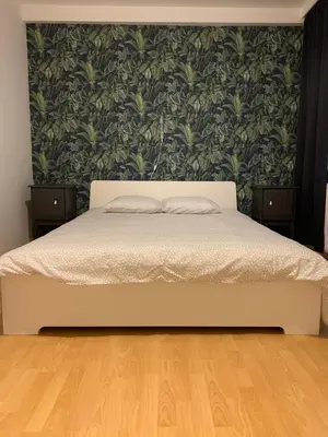 a bedroom with a bed with a green wall at Anna Place in Ghent