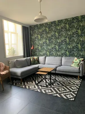 a living room with a couch and a table at Anna Place in Ghent