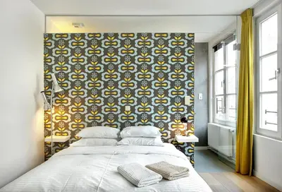 a bedroom with a large bed and a large wall at Alphabed & Bike in Ghent