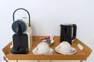 a wooden shelf with a coffee maker and a blender at Alphabed & Bike in Ghent