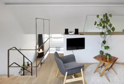 a living room with a chair and a tv at Alphabed & Bike in Ghent