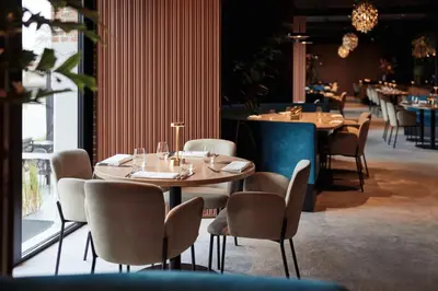 a restaurant with tables and chairs in a room at Van der Valk Hotel Mechelen in Mechelen