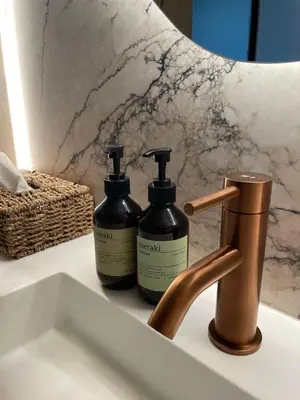 two bottles of soap on a sink next to a faucet at Relax Select in Munte