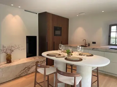 a white table in a kitchen with chairs and wine glasses at Relax Select in Munte
