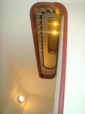 a light hanging on the ceiling of a room at Appart-hôtel Maison de la Lune - petite Auberge d'Etterbeek in Brussels
