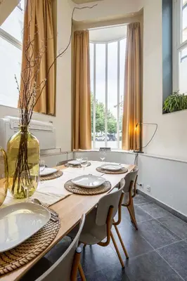 a dining room with a wooden table and chairs at SHWAY - The Red With Pearls in Antwerp