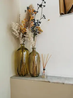 three vases sitting on a counter with flowers in them at SHWAY - The Red With Pearls in Antwerp