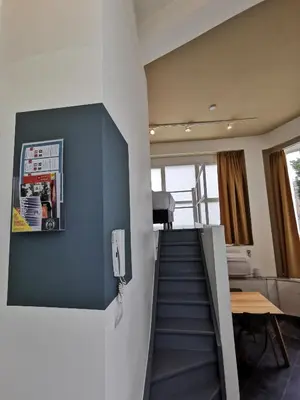a staircase in a room with a blue wall at SHWAY - The Red With Pearls in Antwerp
