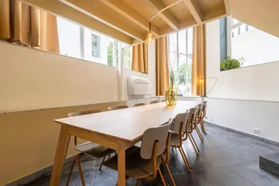 a conference room with a wooden table and chairs at SHWAY - The Red With Pearls in Antwerp