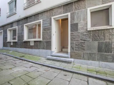a brick building with a white door and windows at studio medieval city center at river de Leie in Ghent