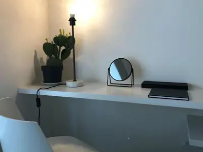 a desk with a mirror and a lamp on it at studio medieval city center at river de Leie in Ghent