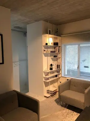 a living room with two couches and a window at studio medieval city center at river de Leie in Ghent
