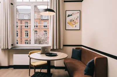 a living room with a couch and a table with a laptop at Getaway Gent in Ghent