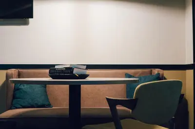 a table and a couch with a table and a chair at Getaway Gent in Ghent
