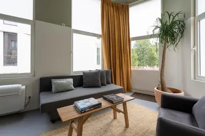 a living room with a couch and a coffee table at SHWAY - The Black Pants in Antwerp