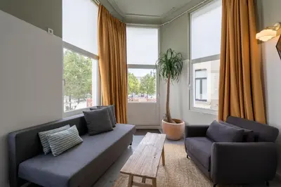 a living room with a couch and two chairs and a table at SHWAY - The Black Pants in Antwerp