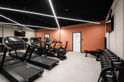 a gym with several treadmills and exercise bikes at A-STAY Antwerp in Antwerp
