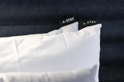 a white bed with two pillows on it at A-STAY Antwerp in Antwerp