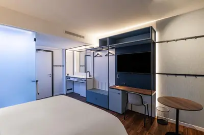 a bedroom with a bed and a desk and a table at A-STAY Antwerp in Antwerp