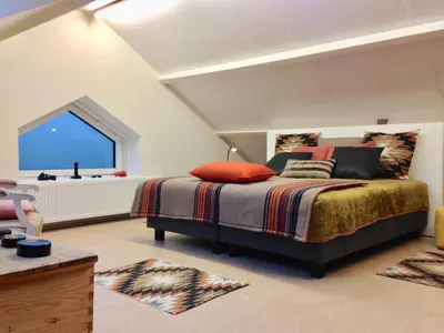 a bedroom with a bed and a large window at GOLF APARTMENT in Schilde