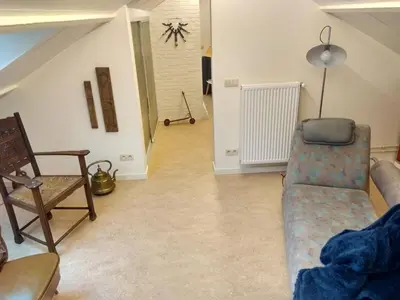 a living room with a couch and a chair at GOLF APARTMENT in Schilde