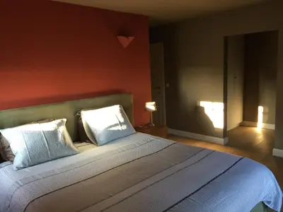 a bedroom with a large bed with two pillows at Bed and Breakfast Bobilou in Kalmthout