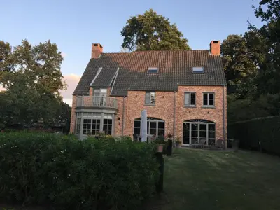 a large red brick house with a roof at Bed and Breakfast Bobilou in Kalmthout