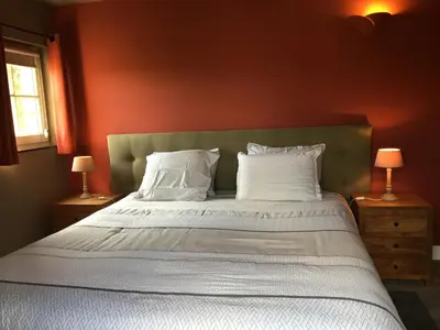 a bedroom with a large bed with white pillows at Bed and Breakfast Bobilou in Kalmthout