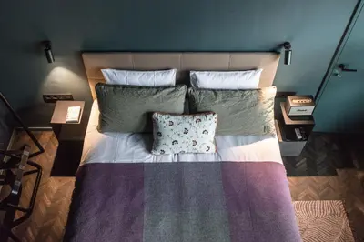 a bed with a pillow on it in a bedroom at Maison Margo in Ghent