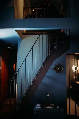 a staircase in a room with a blue wall at Maison Margo in Ghent