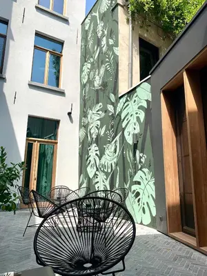 a group of benches sitting in front of a building at Maison Margo in Ghent