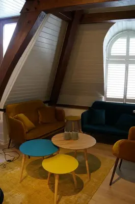 a living room with a couch and a table at Charming Suites Jan Zonder Vrees in Antwerp