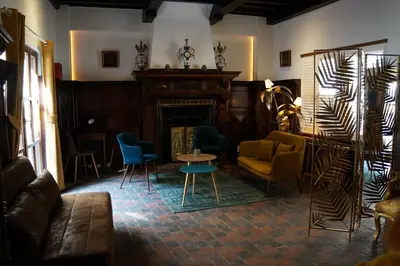 a living room with chairs and a fireplace at Charming Suites Jan Zonder Vrees in Antwerp
