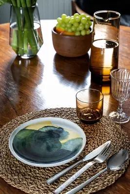 a wooden table with a plate and silverware on it at Studio Spiegelhof in Ghent