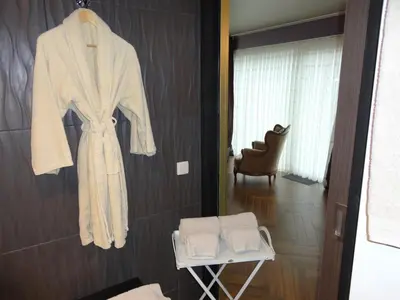 a robe hanging on a wall in a bathroom at Art Of Dreams Deluxe 4 stars in Laakdal