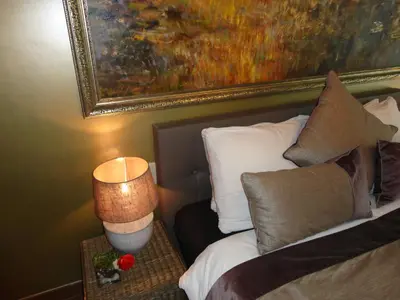a bedroom with a bed with a painting on the wall at Art Of Dreams Deluxe 4 stars in Laakdal