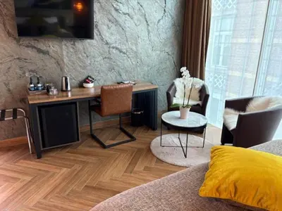 a bedroom with a desk and chairs and a bed at Art Of Dreams Deluxe 4 stars in Laakdal