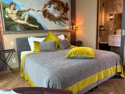 a bedroom with a bed with a painting on the wall at Art Of Dreams Deluxe 4 stars in Laakdal