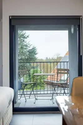 a view of a balcony with a table and chairs at Résidence la floraison in Brussels