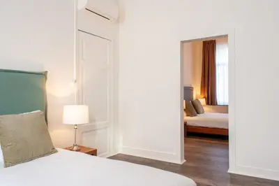 a hotel room with a bed and a bedroom with a bed sidx sidx at La Lys Rooms & Suites in Ghent