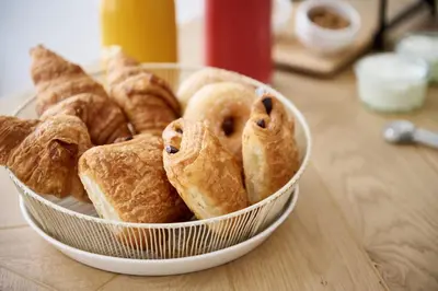 a bowl of pastries sitting on a table at La Lys Rooms & Suites in Ghent
