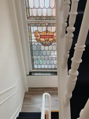 a stairway with a stained glass window at La Lys Rooms & Suites in Ghent