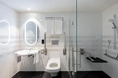 a bathroom with a toilet and a sink and a shower at Residence Inn by Marriott Ghent in Ghent
