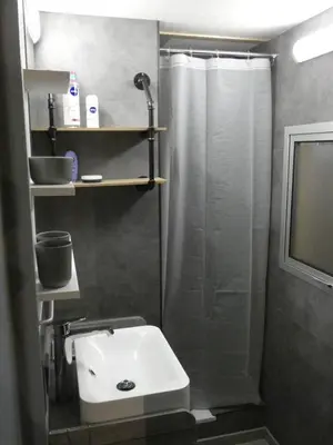 a bathroom with a shower and a white sink at Vakantiewoning De Kleine Duinberg - Chalet Nr 11 in Retie