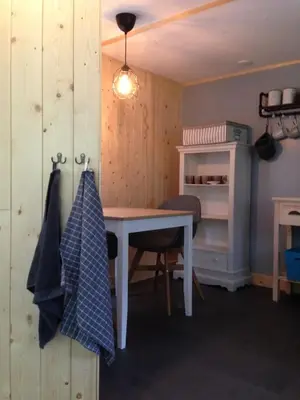 a room with a desk and a table and a shelf at Vakantiewoning De Kleine Duinberg - Chalet Nr 11 in Retie