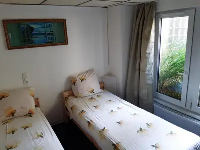 a bedroom with two beds and a window at Casa ENRICO in Antwerp